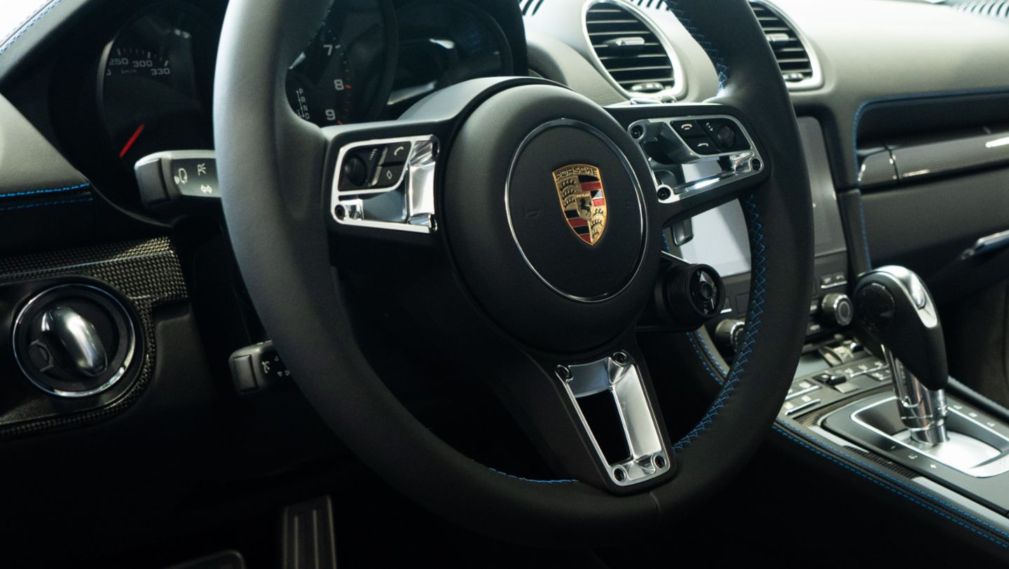 Timón personalizado con costura decorativa en color de contraste del 718 Cayman GTS, color azul shark, que viene siendo exhibido en el Porsche Center Lima para dar a conocer al público el Porsche Exclusive Manufaktur, programa de individualización que ofrece más de 700 opciones para transformar cada vehículo en una pieza única, Lima, Perú, Porsche AG.